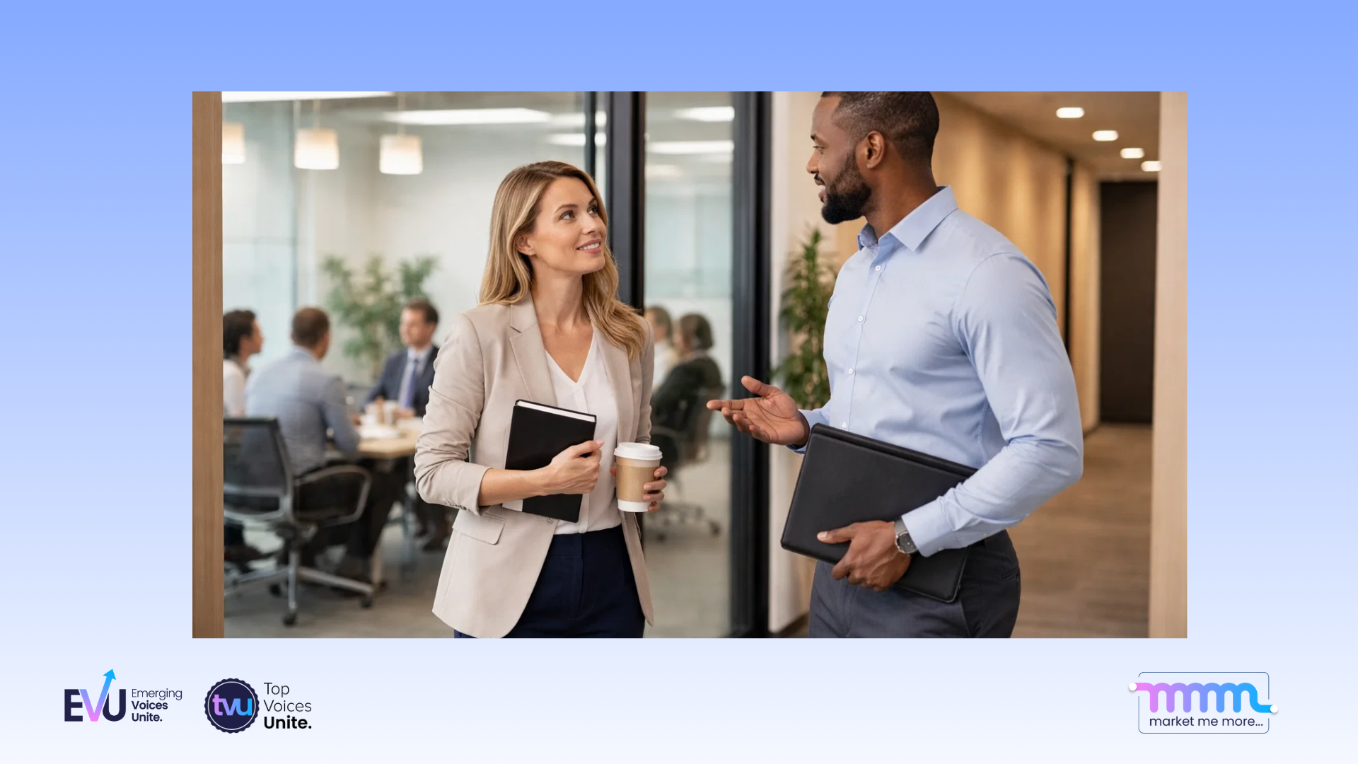 two professionals in quiet conversation away from meeting room
